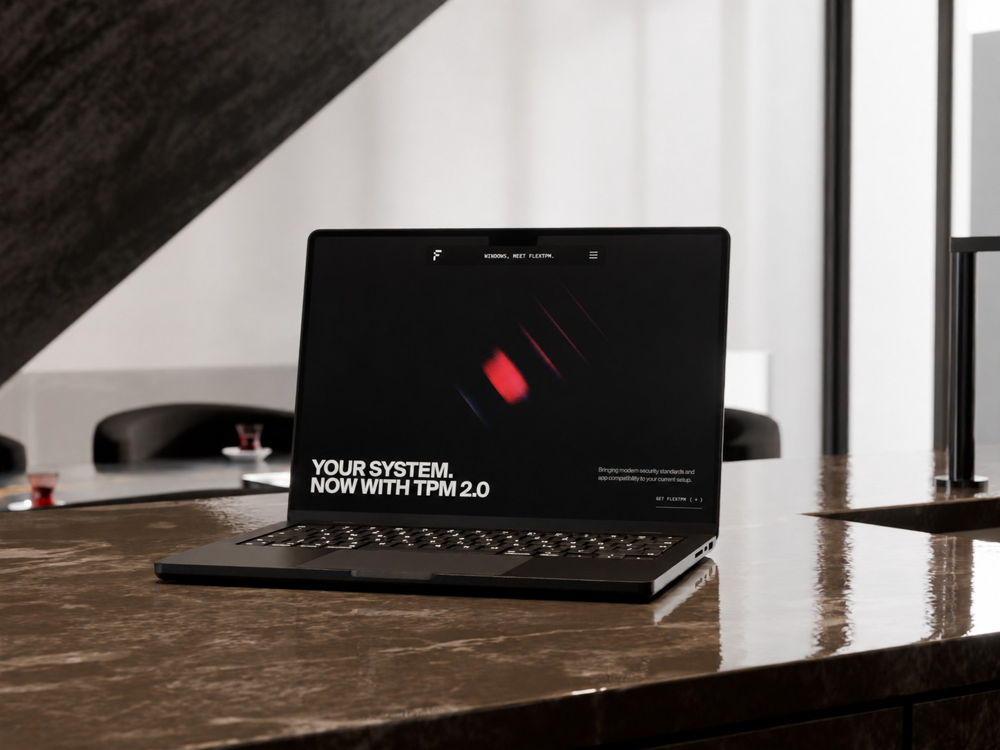 A black laptop displaying the FlexTPM homepage in a modern studio